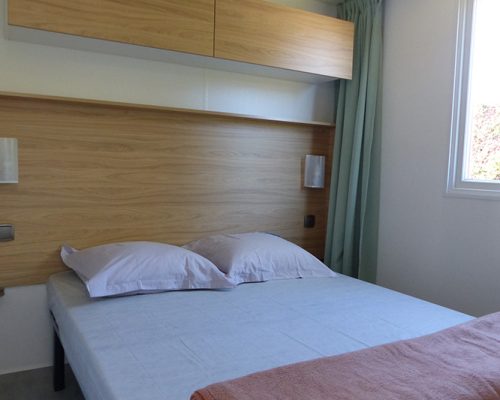 Chambre adulte avec lit 2 places du mobil-home 4-6 personnes en location au camping 4 étoiles en région Pays-de-la-Loire La Buzelière